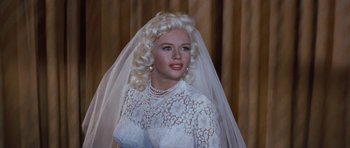 Movie still from “The Girl Can't Help It” (1956), directed by Frank Tashlin – A wax statue of a woman in a wedding dress; Close Up shot, Over the shoulder angle