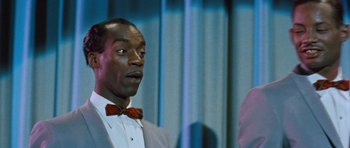 Movie still from “The Girl Can't Help It” (1956), directed by Frank Tashlin – A man in a suit and bow tie standing next to another man in a suit and bow tie; Close Up shot, Over the shoulder angle