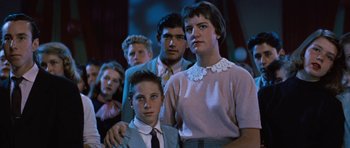 Movie still from “The Girl Can't Help It” (1956), directed by Frank Tashlin – A group of people standing together in a room; Medium shot, Low angle