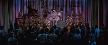 Movie still from “The Girl Can't Help It” (1956), directed by Frank Tashlin – A group of people on a stage with a band; Extreme Wide shot, High angle