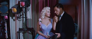 Movie still from “The Girl Can't Help It” (1956), directed by Frank Tashlin – A man and a woman dressed up in formal wear; Medium shot, Low angle