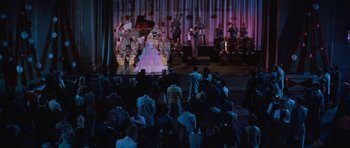 Movie still from “The Girl Can't Help It” (1956), directed by Frank Tashlin – A group of people sitting on a stage watching a performance; Extreme Wide shot, High angle