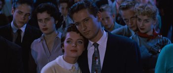 Movie still from “The Girl Can't Help It” (1956), directed by Frank Tashlin – A man and a woman standing next to each other in a crowd; Close Up shot, Low angle