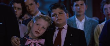 Movie still from “The Girl Can't Help It” (1956), directed by Frank Tashlin – Two young men in suits and ties posing for a picture; Close Up shot, Low angle