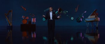 Movie still from “The Girl Can't Help It” (1956), directed by Frank Tashlin – A man juggling a bunch of objects in the air; Wide shot, High angle