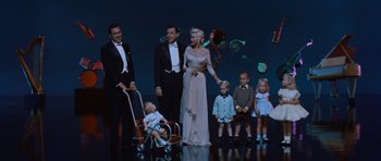 Movie still from “The Girl Can't Help It” (1956), directed by Frank Tashlin – A group of people standing on a stage with balloons; Wide shot, High angle
