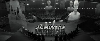 Movie still from “The Giver” (2014), directed by Phillip Noyce – A group of people standing in front of an audience; Wide shot, High angle