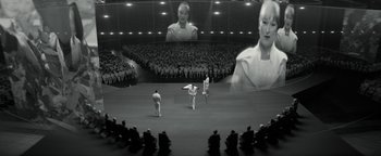 Movie still from “The Giver” (2014), directed by Phillip Noyce – A group of people are watching a performance in front of an audience; Wide shot, High angle