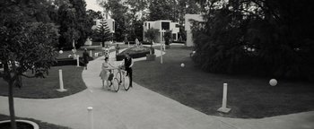 Movie still from “The Giver” (2014), directed by Phillip Noyce – A man on a bike and a woman on a bicycle; Extreme Wide shot, High angle