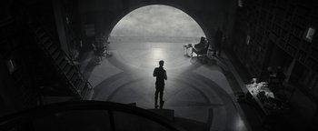 Movie still from “The Giver” (2014), directed by Phillip Noyce – A man standing in front of an arch in a building; Extreme Wide shot, High angle