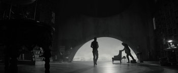 Movie still from “The Giver” (2014), directed by Phillip Noyce – A man standing in front of an open doorway; Wide shot, Low angle