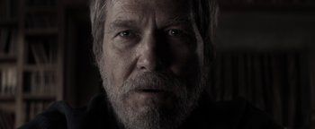 Movie still from “The Giver” (2014), directed by Phillip Noyce – An old man with a beard and a goatee stares at the camera; Close Up shot, Over the shoulder angle