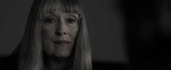 Movie still from “The Giver” (2014), directed by Phillip Noyce – An older woman with long hair is looking at the camera; Close Up shot, Low angle