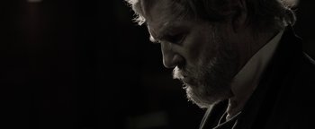 Movie still from “The Giver” (2014), directed by Phillip Noyce – A person with a beard looking down; Close Up shot, Low angle