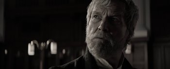 Movie still from “The Giver” (2014), directed by Phillip Noyce – An old man with a beard and a white beard; Close Up shot, Over the shoulder angle