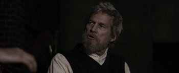 Movie still from “The Giver” (2014), directed by Phillip Noyce – An older man with a beard and a white shirt; Close Up shot, Over the shoulder angle