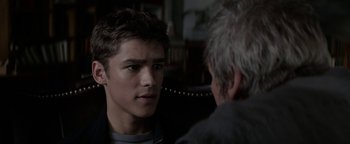 Movie still from “The Giver” (2014), directed by Phillip Noyce – A young man talking to an older man in a chair; Close Up shot, Over the shoulder angle