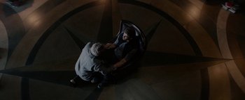 Movie still from “The Giver” (2014), directed by Phillip Noyce – An overhead view of a person sitting in a chair; Wide shot, Overhead angle