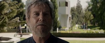 Movie still from “The Giver” (2014), directed by Phillip Noyce – An older man with a gray beard looking at the camera; Close Up shot, Low angle