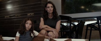 Movie still from “The Giver” (2014), directed by Phillip Noyce – A woman sitting next to a little girl in a room; Medium shot, Low angle