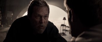 Movie still from “The Giver” (2014), directed by Phillip Noyce – A man with a goatee is looking at another man; Close Up shot, Over the shoulder angle