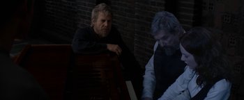 Movie still from “The Giver” (2014), directed by Phillip Noyce – A man sitting next to another man playing a piano; Medium shot, Over the shoulder angle