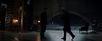 Movie still from “The Giver” (2014), directed by Phillip Noyce – Two men standing on a stage in the dark; Wide shot, Low angle