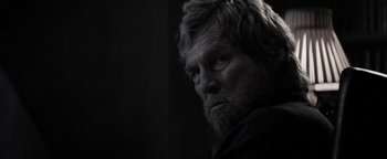 Movie still from “The Giver” (2014), directed by Phillip Noyce – A black and white photo of a man with a beard; Close Up shot, Over the shoulder angle