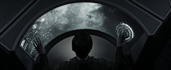 Movie still from “The Giver” (2014), directed by Phillip Noyce – A man is looking into a large screen; Medium shot, High angle