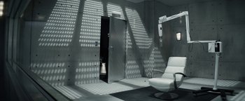 Movie still from “The Giver” (2014), directed by Phillip Noyce – A room with a chair and a mirror in it; Wide shot, High angle