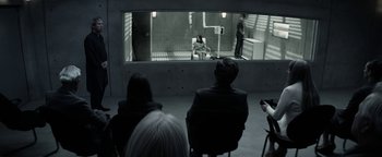 Movie still from “The Giver” (2014), directed by Phillip Noyce – A group of people sitting in front of a mirror; Wide shot, High angle