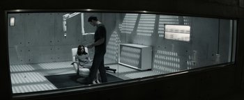 Movie still from “The Giver” (2014), directed by Phillip Noyce – A man and a woman are in a room; Wide shot, High angle