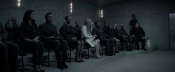 Movie still from “The Giver” (2014), directed by Phillip Noyce – A group of people sitting in a room; Wide shot, High angle