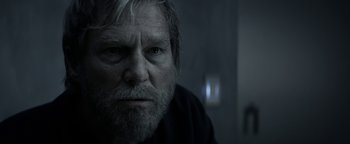 Movie still from “The Giver” (2014), directed by Phillip Noyce – A person with a beard looking at the camera; Close Up shot, Over the shoulder angle