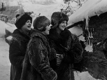 Movie still from “The Gold Rush” (1925), directed by Charles Chaplin – A group of women standing next to each other; Medium shot, High angle