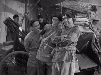 Movie still from “The Good Earth” (1937), directed by Sidney Franklin – A black and white photo of a group of people; Medium shot, High angle