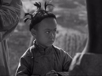 Movie still from “The Good Earth” (1937), directed by Sidney Franklin – A young boy with a mohawk is looking at the camera; Close Up shot, High angle