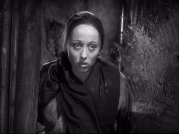 Movie still from “The Good Earth” (1937), directed by Sidney Franklin – A black and white photo of a woman with a scarf around her neck; Close Up shot, High angle