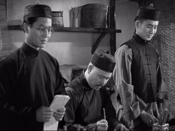 Movie still from “The Good Earth” (1937), directed by Sidney Franklin – A group of men standing next to each other in a room; Medium shot, High angle