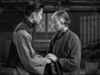 Movie still from “The Good Earth” (1937), directed by Sidney Franklin – A man and a woman holding each other's hands; Medium shot, Over the shoulder angle