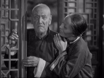 Movie still from “The Good Earth” (1937), directed by Sidney Franklin – An older man and a younger woman looking at each other; Medium shot, Low angle