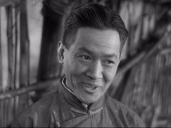 Movie still from “The Good Earth” (1937), directed by Sidney Franklin – An older asian man smiling for the camera; Close Up shot, Low angle