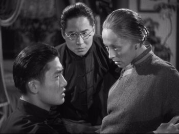 Movie still from “The Good Earth” (1937), directed by Sidney Franklin – A group of people standing next to each other in a room; Medium shot, Over the shoulder angle