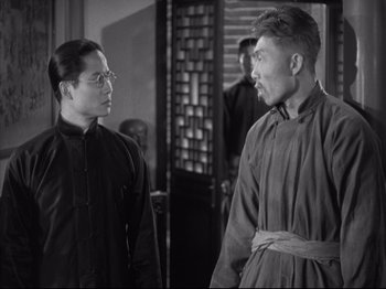 Movie still from “The Good Earth” (1937), directed by Sidney Franklin – A man and a woman standing next to each other in a room; Medium shot, Over the shoulder angle