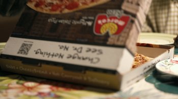 Movie still from “The Good Lie” (2014), directed by Philippe Falardeau – A box of pizza with writing on it; Extreme Close Up shot, High angle