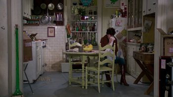 Movie still from “The Goodbye Girl” (1977), directed by Herbert Ross – Two women sitting at a table in a kitchen; Wide shot, High angle