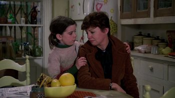 Movie still from “The Goodbye Girl” (1977), directed by Herbert Ross – A woman and a young girl sitting at a kitchen table; Medium shot, Over the shoulder angle