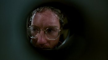 Movie still from “The Goodbye Girl” (1977), directed by Herbert Ross – A man wearing glasses looking through a camera lens; Extreme Close Up shot, Low angle