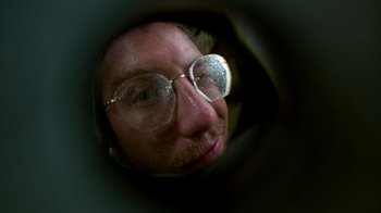 Movie still from “The Goodbye Girl” (1977), directed by Herbert Ross – A man wearing glasses looking through a lens; Extreme Close Up shot, Low angle