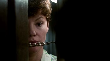 Movie still from “The Goodbye Girl” (1977), directed by Herbert Ross – A woman holding a chain in her mouth; Close Up shot, Low angle